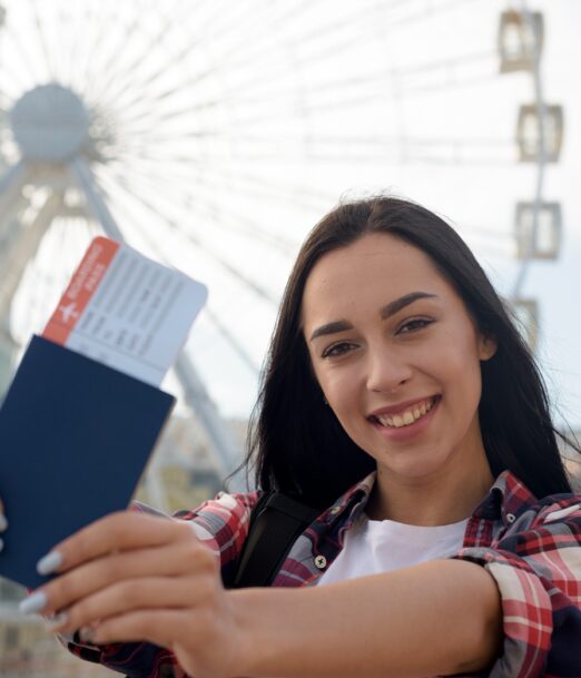 portrait-smiling-woman-showing-air-ticket-passport (1)