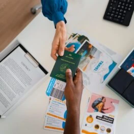 top-view-hands-holding-travel-documents_23-2150433383-263x263